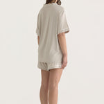 Muse Short PJs — Dusk: Relaxed-fit beige pajama set with short sleeves and shorts, featuring white piping detail.