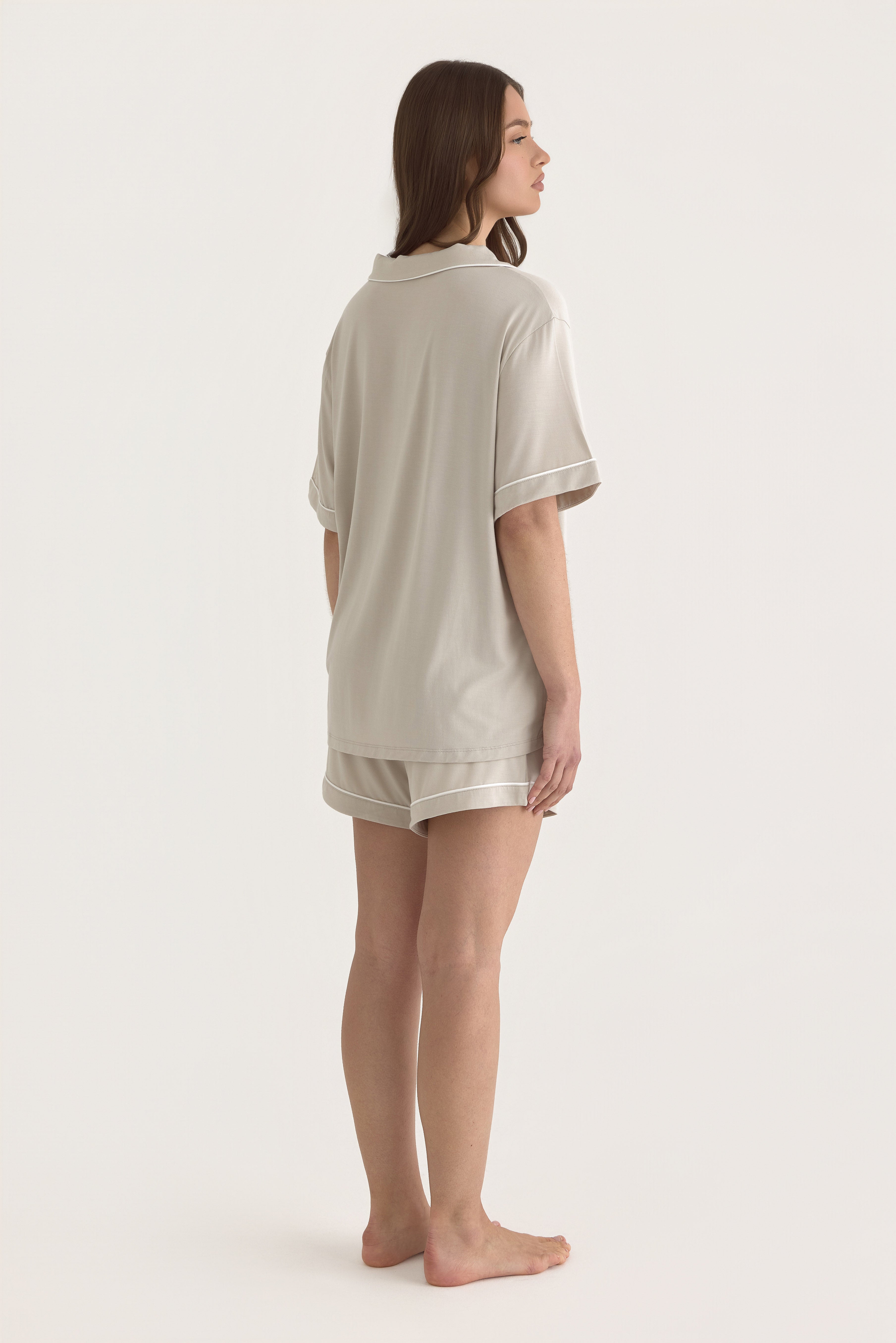 Muse Short PJs — Dusk: Relaxed-fit beige pajama set with short sleeves and shorts, featuring white piping detail.