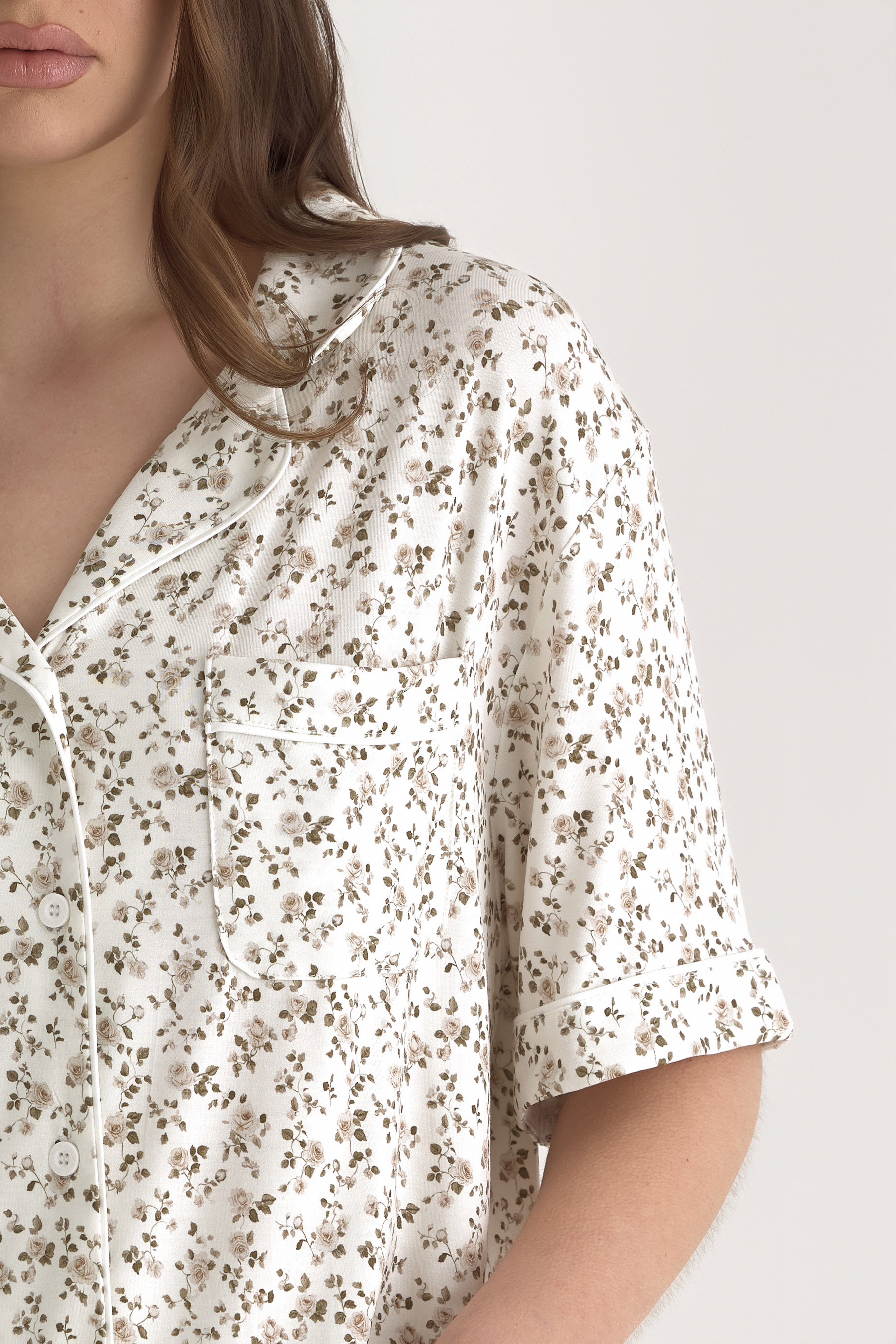 Muse Short PJs — Rose Garden: Close-up of women's short-sleeve pajama top, featuring a delicate rose garden print on a white background.