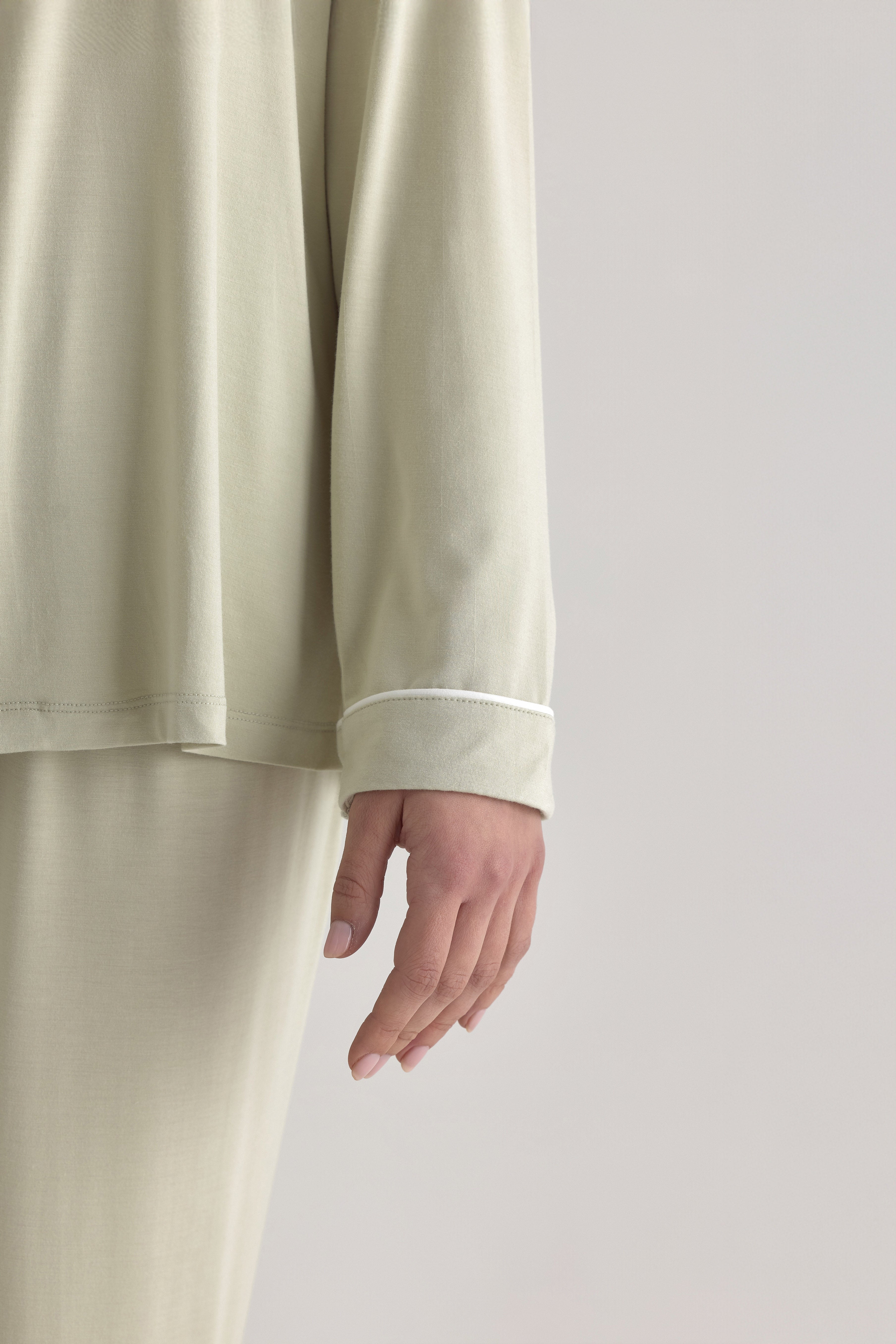 Muse Long PJs in Soft Sage:  Relaxed-fit sage green pajamas with long sleeves and a subtle white piping detail.