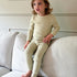 Mini Muse PJs in Soft Sage: Adorable toddler in comfy sage green pajamas